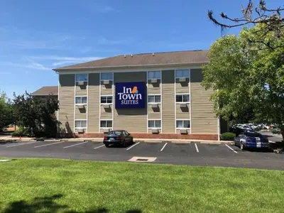 a building with a sign in a parking lot at InTown Suites Extended Stay Columbus OH - I-70E Hamilton Rd in Columbus