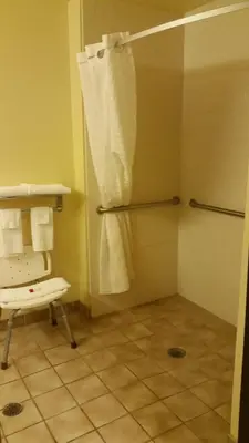 a bathroom with a shower with a shower curtain at Super 8 by Wyndham Wheeling WV in Wheeling