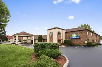 a building with a sign that reads pay gym at Days Inn by Wyndham Middletown in Middletown