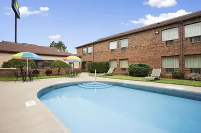 a large swimming pool in front of a building at Days Inn by Wyndham Middletown in Middletown