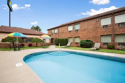 a swimming pool in front of a building at Days Inn by Wyndham Middletown in Middletown