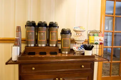 a table with four coffee bottles on top of it at Country Inn & Suites by Radisson, Macedonia, OH in Macedonia