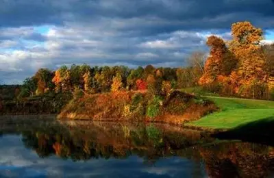 a view of a lake with trees in the background at Country Inn & Suites by Radisson, Macedonia, OH in Macedonia