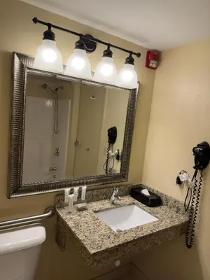 a bathroom with a sink and a mirror at Country Inn & Suites by Radisson, Macedonia, OH in Macedonia
