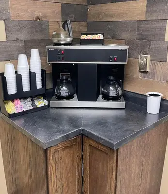 a counter with a coffee maker in a kitchen at The Woodridge Inn in Connersville