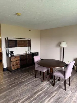 a room with a table and chairs and a kitchen at The Woodridge Inn in Connersville