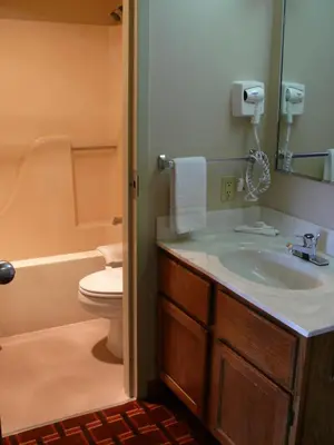 a bathroom with a sink and a toilet at The Woodridge Inn in Connersville
