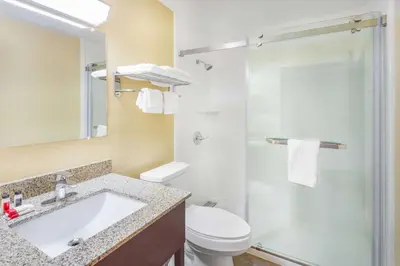 a bathroom with a sink and a toilet and a shower at Super 8 by Wyndham Waynesburg in Waynesburg