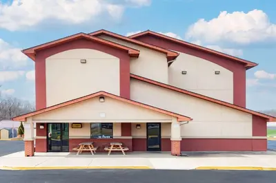 a building with two tables outside of it at Super 8 by Wyndham Waynesburg in Waynesburg