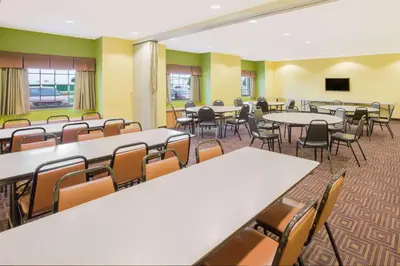 a classroom with tables and chairs in a room at Microtel Inn & Suites by Wyndham Delphos in Delphos