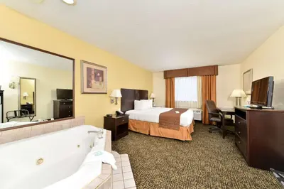 a hotel room with a bed and a bath tub at Best Western Elyria in Elyria