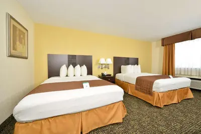 a hotel room with two beds and a window at Best Western Elyria in Elyria