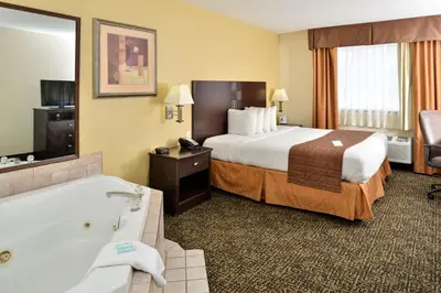 a hotel room with a bed and a bath tub at Best Western Elyria in Elyria