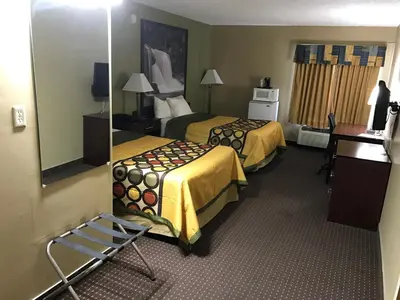 a hotel room with two beds and a mirror at Super 8 by Wyndham Miamisburg Dayton S Area OH in Miamisburg