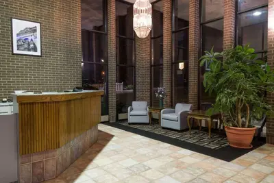 a lobby with a bar and chairs in a building at Super 8 by Wyndham Miamisburg Dayton S Area OH in Miamisburg