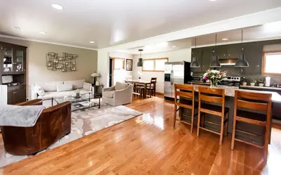 a kitchen and living room with a couch and a table at The Broadway Guest House in Granville