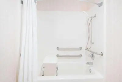 a bathroom with a shower and a sink at Ramada by Wyndham Strasburg Dover in Strasburg
