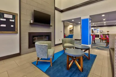 a waiting room with chairs and a fireplace at Holiday Inn Express Chillicothe East by IHG in Chillicothe