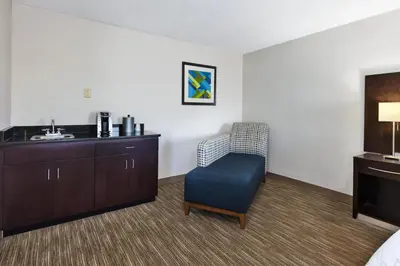 a hotel room with a chair and a sink at Holiday Inn Express Chillicothe East by IHG in Chillicothe