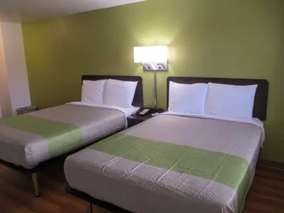 two beds in a room with green walls at Motel 6-North Olmsted, OH - Cleveland in North Olmsted