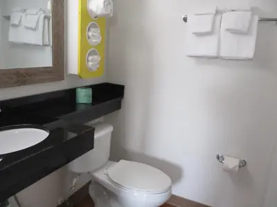 a bathroom with a toilet and a sink and towels at Motel 6-North Olmsted, OH - Cleveland in North Olmsted
