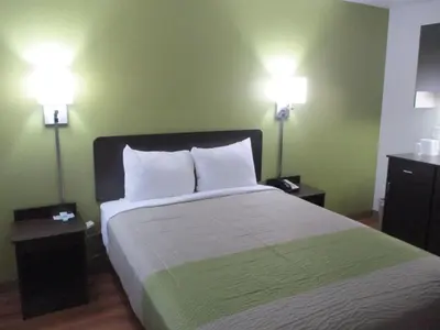 a bedroom with a bed with two lights on the wall at Motel 6-North Olmsted, OH - Cleveland in North Olmsted
