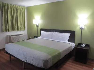 a bedroom with a large bed with two lamps at Motel 6-North Olmsted, OH - Cleveland in North Olmsted