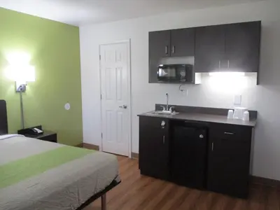 a bedroom with a bed and a kitchen with a sink at Motel 6-North Olmsted, OH - Cleveland in North Olmsted