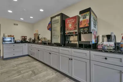 a kitchen with white cabinets and boxes of food at Baymont by Wyndham Zanesville in Zanesville