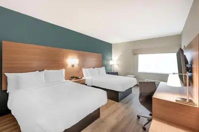 a hotel room with two beds and a desk at Best Western River Cities in Ashland
