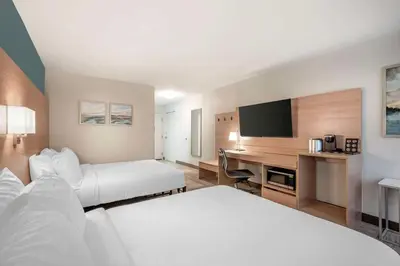 a hotel room with two beds and a desk at Best Western River Cities in Ashland