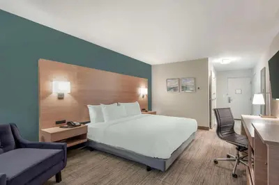 a bedroom with a bed and a desk and a chair at Best Western River Cities in Ashland