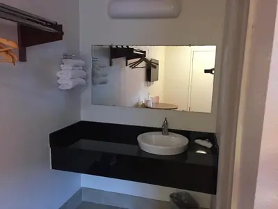 a bathroom with a sink and a mirror at FairBridge Inn Express North Lima in North Lima
