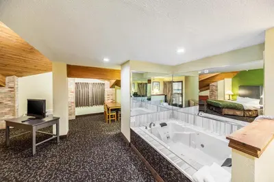 a hotel room with a tub and a bedroom at Quality Inn Decatur near US-224 in Decatur