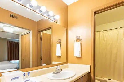 a bathroom with a sink and a mirror at Americas Best Value Inn St. Marys in Saint Marys