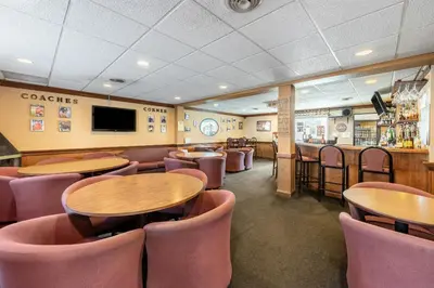 a restaurant with tables and chairs and a bar at Americas Best Value Inn St. Marys in Saint Marys