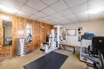 a gym with exercise equipment in a room at Americas Best Value Inn St. Marys in Saint Marys