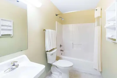 a bathroom with a white toilet and a sink at Days Inn by Wyndham Wooster in Wooster