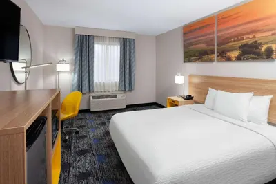 a hotel room with a bed and a desk at Days Inn by Wyndham Wooster in Wooster