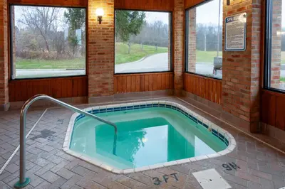 a jacuzzi tub in a building with windows at Days Inn by Wyndham Wooster in Wooster