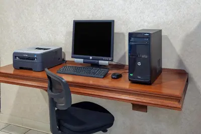 a desk with a desktop computer and a printer at Days Inn by Wyndham Wooster in Wooster