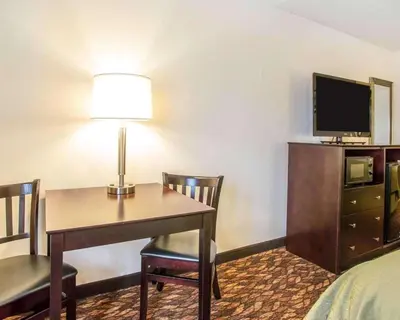 a hotel room with a desk and a tv at Quality Inn St Marys in Villa Nova