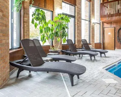a row of chairs sitting next to a swimming pool at Quality Inn St Marys in Villa Nova