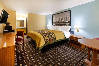 a hotel room with a bed and a television at Super 8 by Wyndham Newcomerstown in Newcomerstown