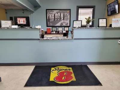a store with arax rug on the floor at Super 8 by Wyndham Newcomerstown in Newcomerstown