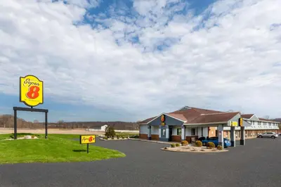 a gas station with a sign in front of it at Super 8 by Wyndham Newcomerstown in Newcomerstown