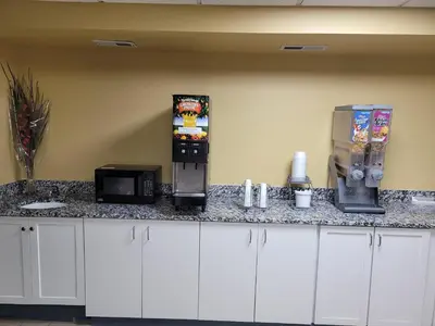 a kitchen with a counter top with a coffee machine at Super 8 by Wyndham Newcomerstown in Newcomerstown