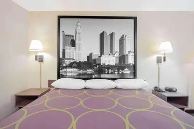 a bedroom with a large picture of a city at Super 8 by Wyndham Ashland in Ashland