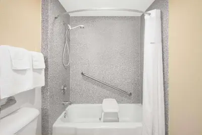 a bathroom with a shower with a tub and a toilet at Super 8 by Wyndham Ashland in Ashland