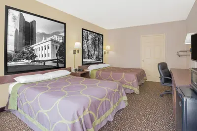 a hotel room with two beds and a desk at Super 8 by Wyndham Ashland in Ashland